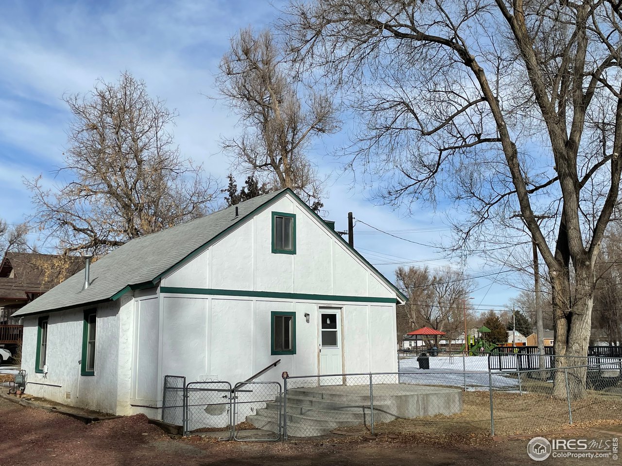 101 Reed Place Longmont, CO 80504 - Photo 6 of 34 a white house that has a tree in front of it
