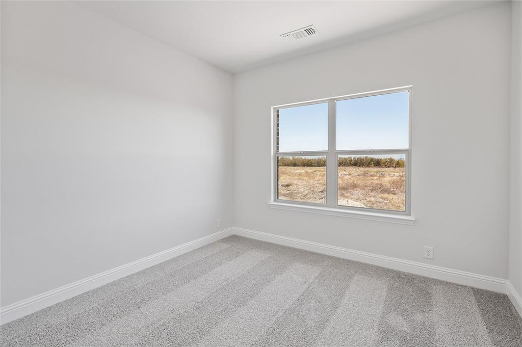 613 Brazos Drive Van Alstyne, TX 75495 - Photo 25 of 29 Spare room with light carpet and baseboards