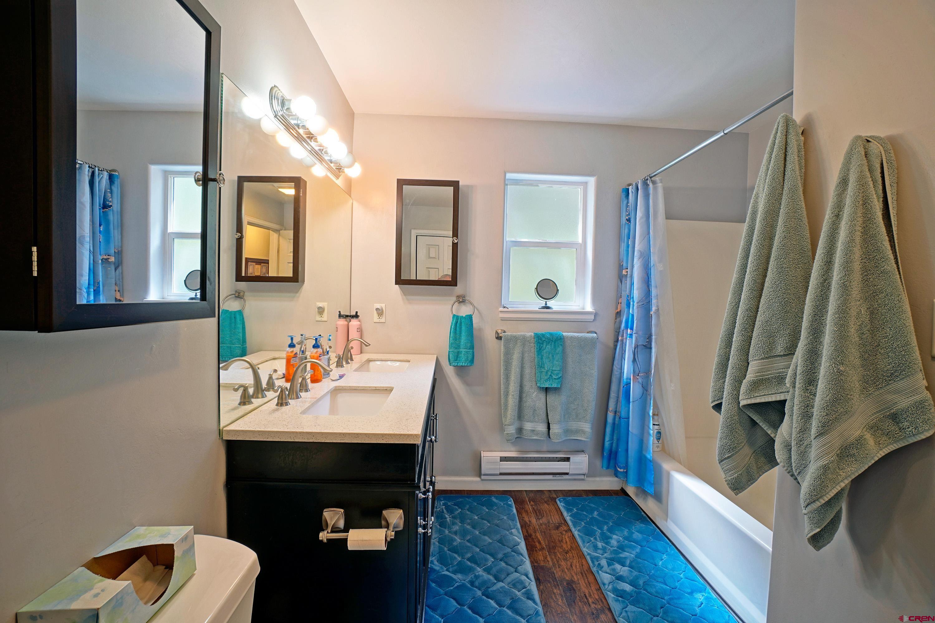1316 Main Street Ouray, CO 81427 - Photo 22 of 39 a bathroom with a sink a mirror and a shower