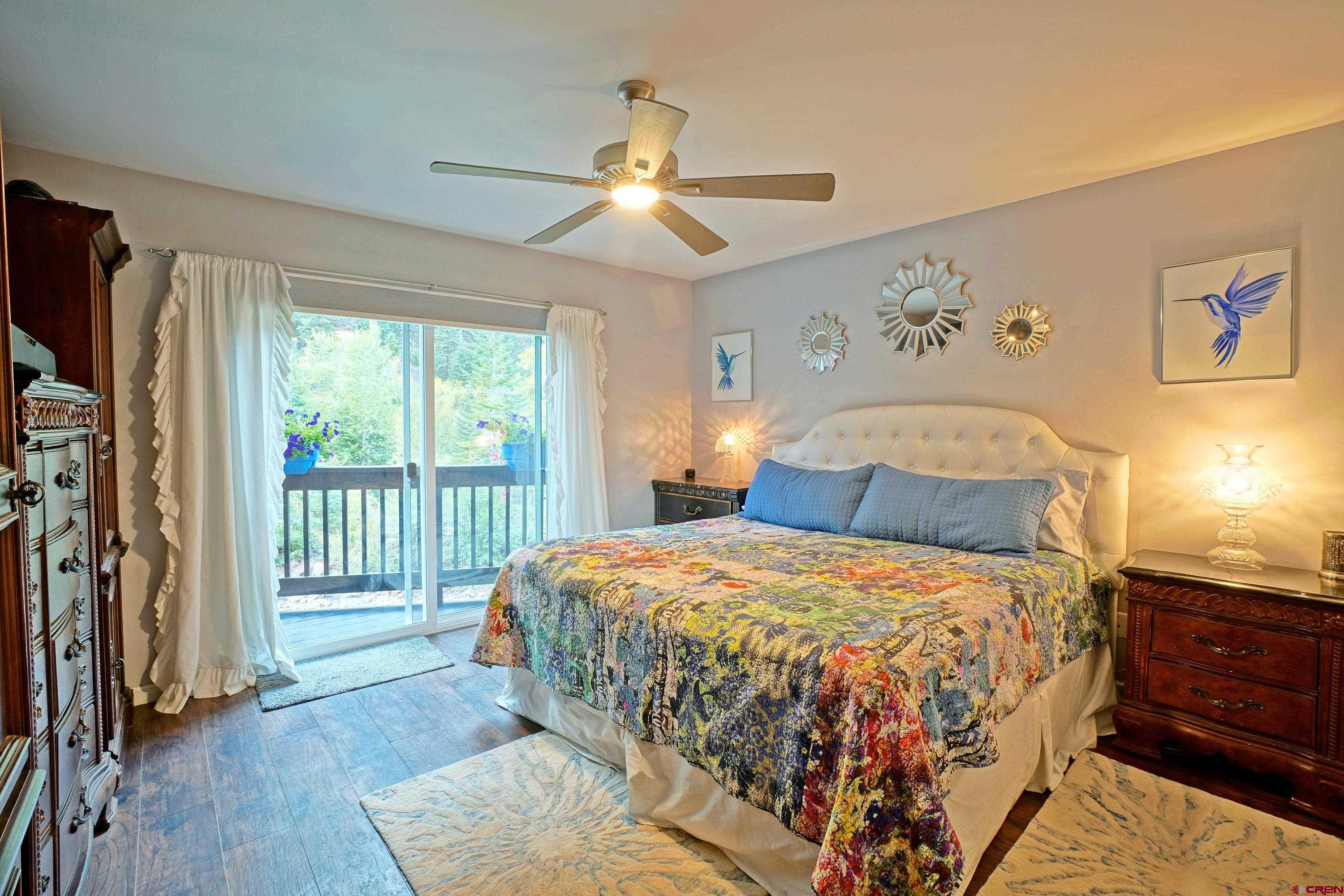 1316 Main Street Ouray, CO 81427 - Photo 24 of 39 a bedroom with a large bed and a chandelier