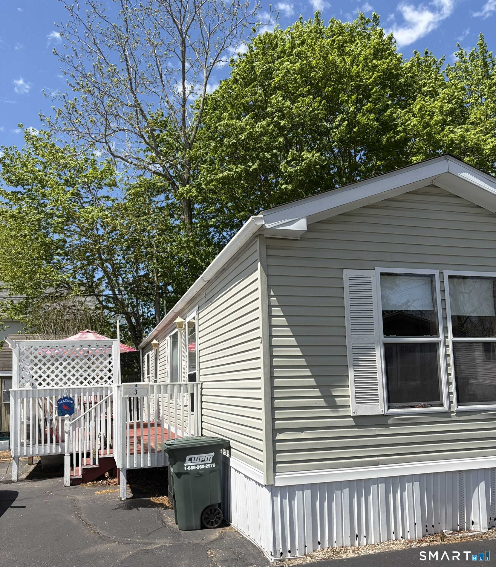 a view of a house with a small yard and wooden fence
