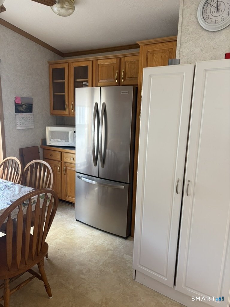 62 Fort Hill Road Groton, CT 06340 - Photo 5 of 11 a kitchen with stainless steel appliances granite countertop a refrigerator a stove a sink with island and chairs