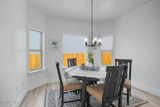 a view of a dining room with a table and chairs