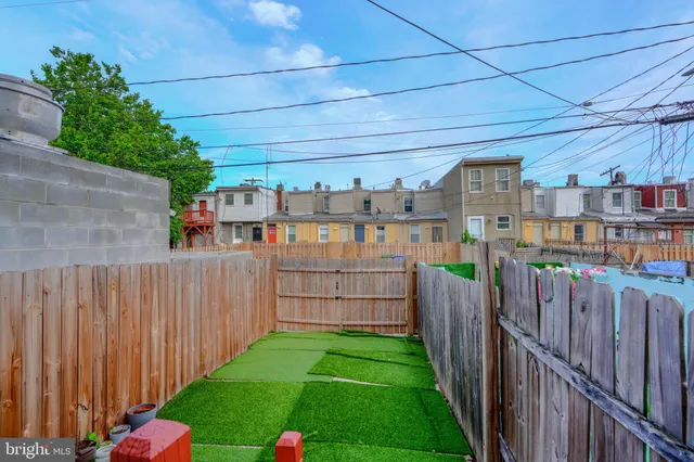 a front view of a house with wooden fence