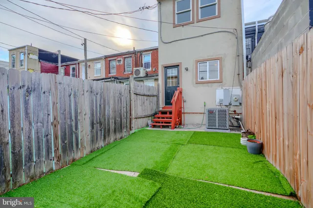 a view of a backyard with table and chairs and a yard