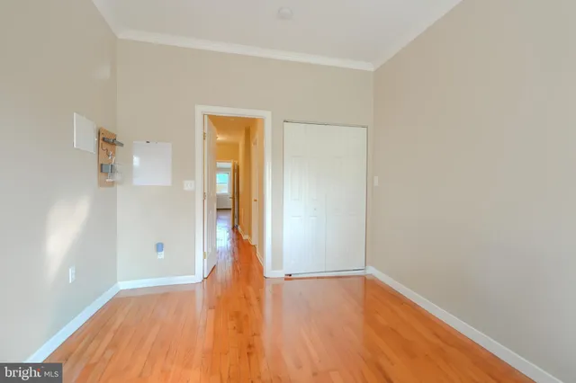 a view of empty room with wooden floor