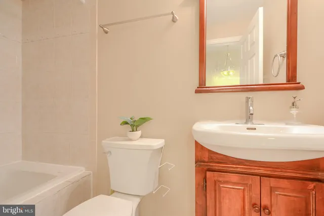 a bathroom with a sink a toilet and tub