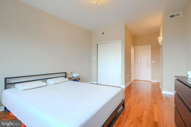 a bed room with a bed and a night stand