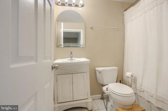 a bathroom with a toilet sink and mirror