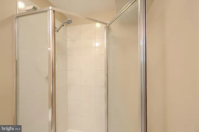 a bathroom with a glass shower door