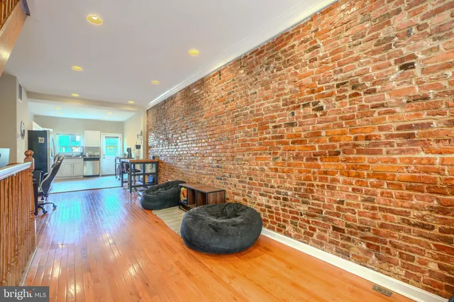 a hallway with a chair and a potted plant