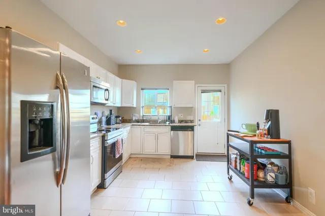 a kitchen with a refrigerator and a sink