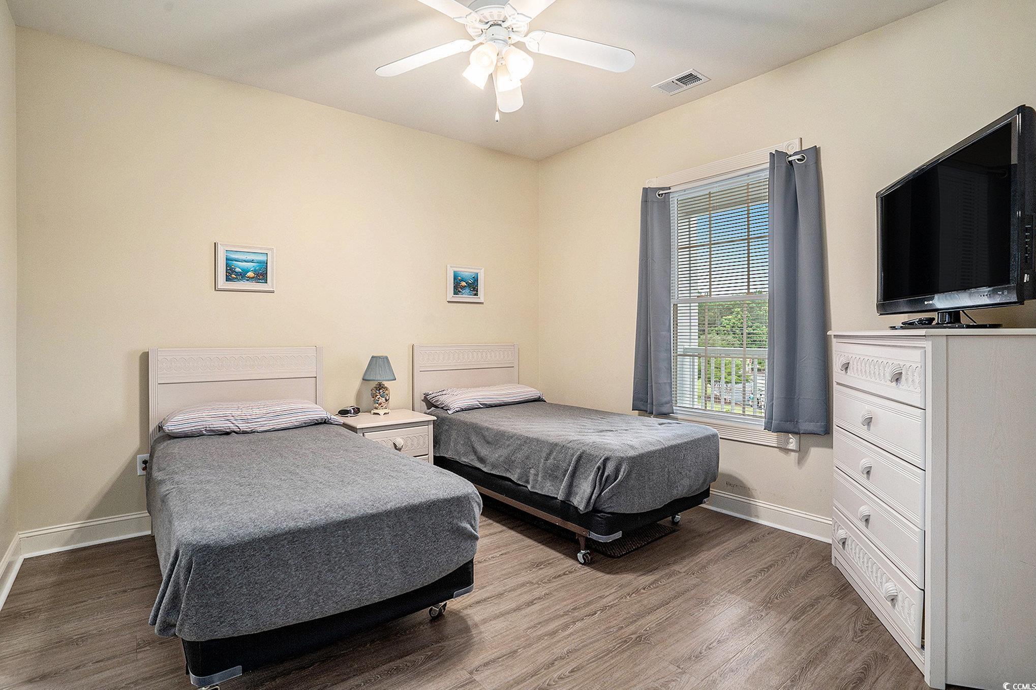 4895 Luster Leaf Circle, Unit 302 Myrtle Beach, SC 29577 - Photo 11 of 20 Bedroom with wood finished floors, baseboards, and