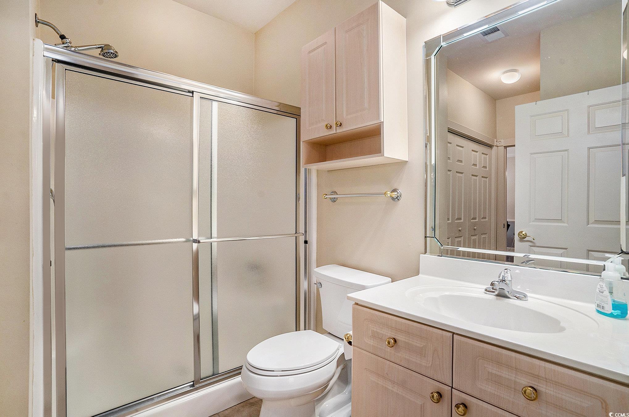 4895 Luster Leaf Circle, Unit 302 Myrtle Beach, SC 29577 - Photo 13 of 20 Bathroom featuring a stall shower, toilet, and van