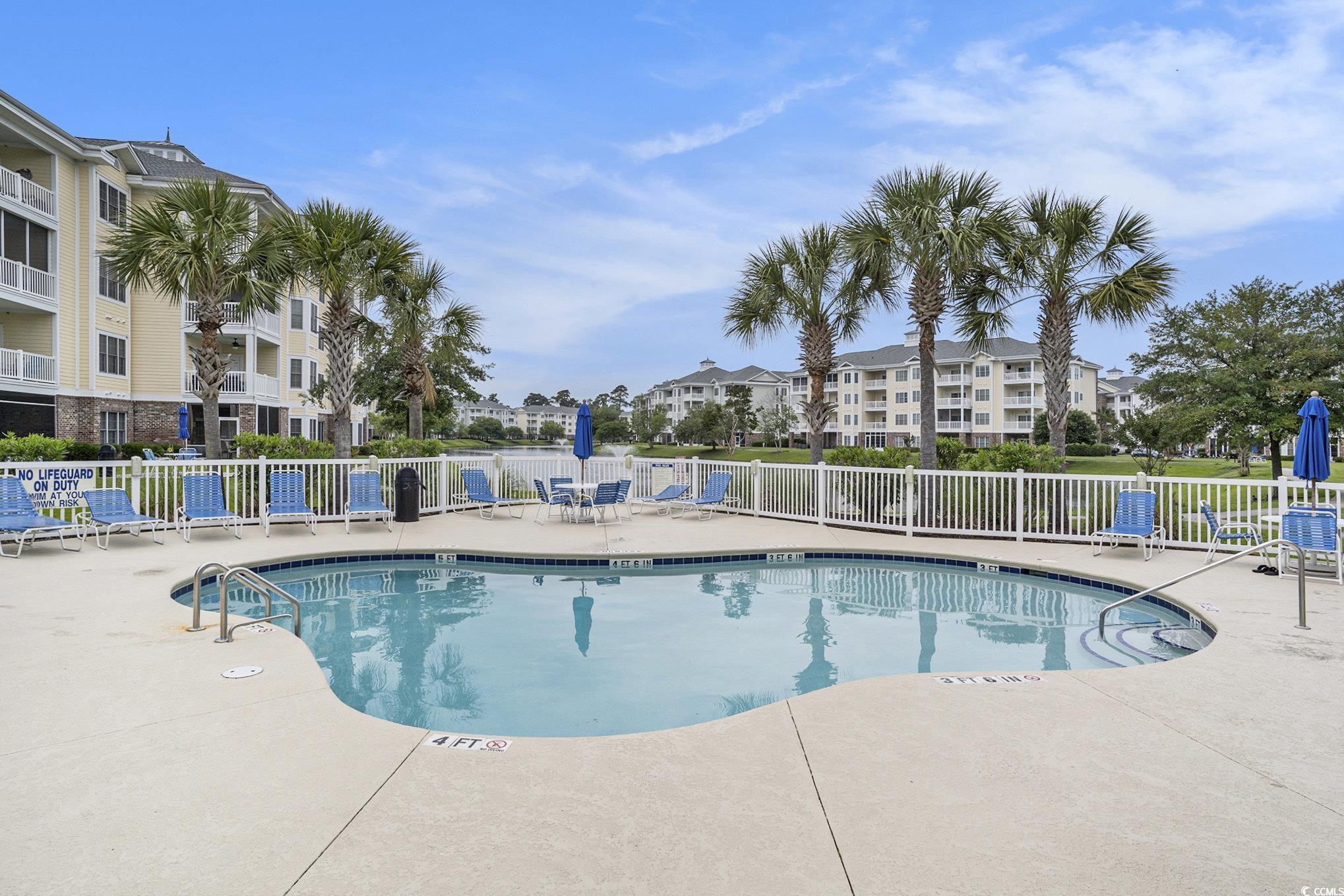 4895 Luster Leaf Circle, Unit 302 Myrtle Beach, SC 29577 - Photo 17 of 20 Community pool with fence and a patio