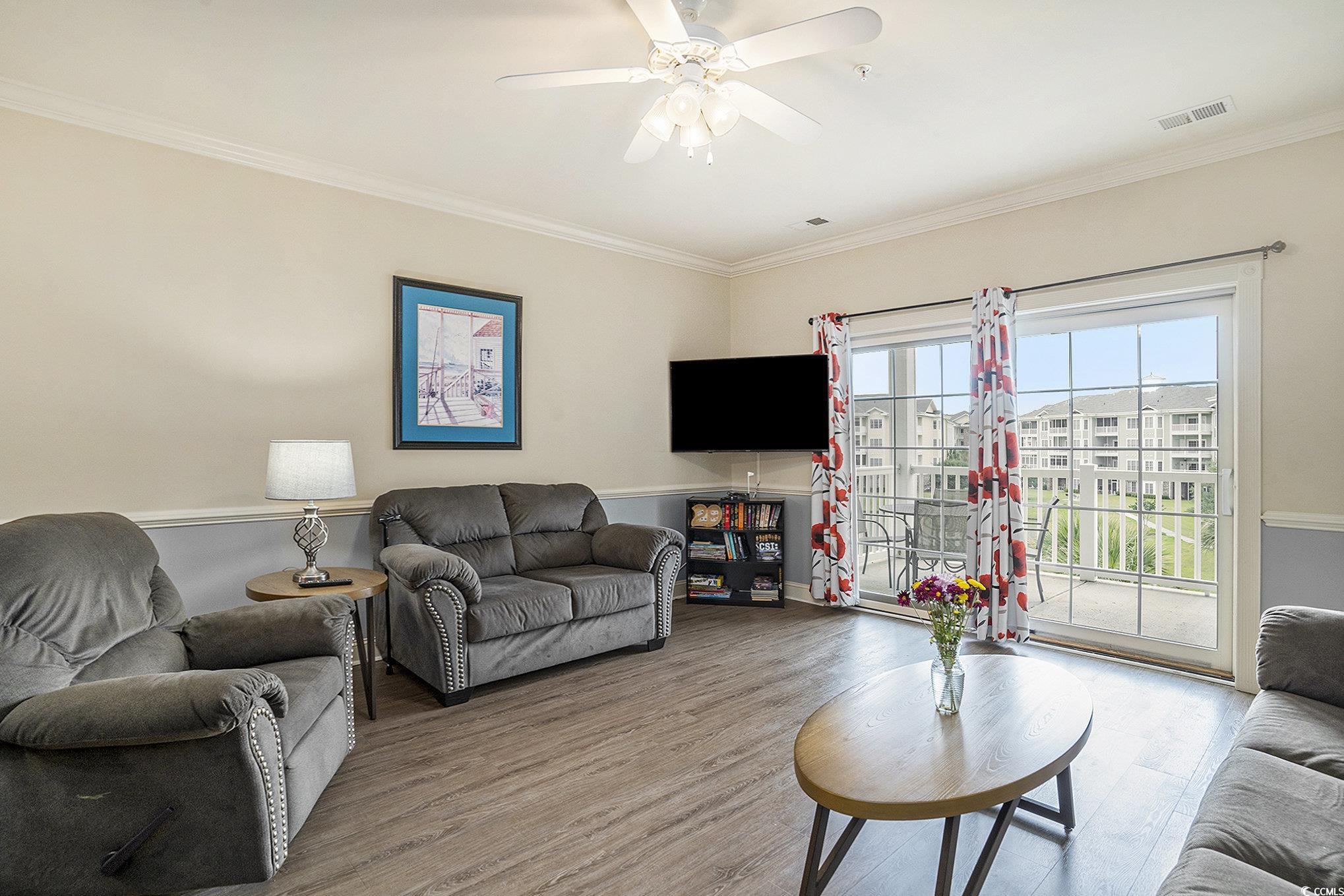 4895 Luster Leaf Circle, Unit 302 Myrtle Beach, SC 29577 - Photo 3 of 20 Living room featuring wood finished floors, crown