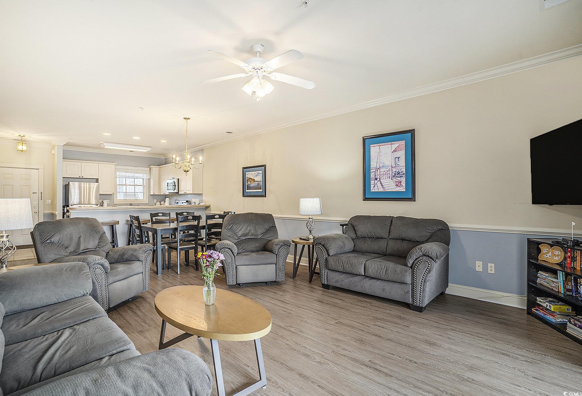 4895 Luster Leaf Circle, Unit 302 Myrtle Beach, SC 29577 - Photo 4 of 20 Living room featuring ornamental molding, a chande