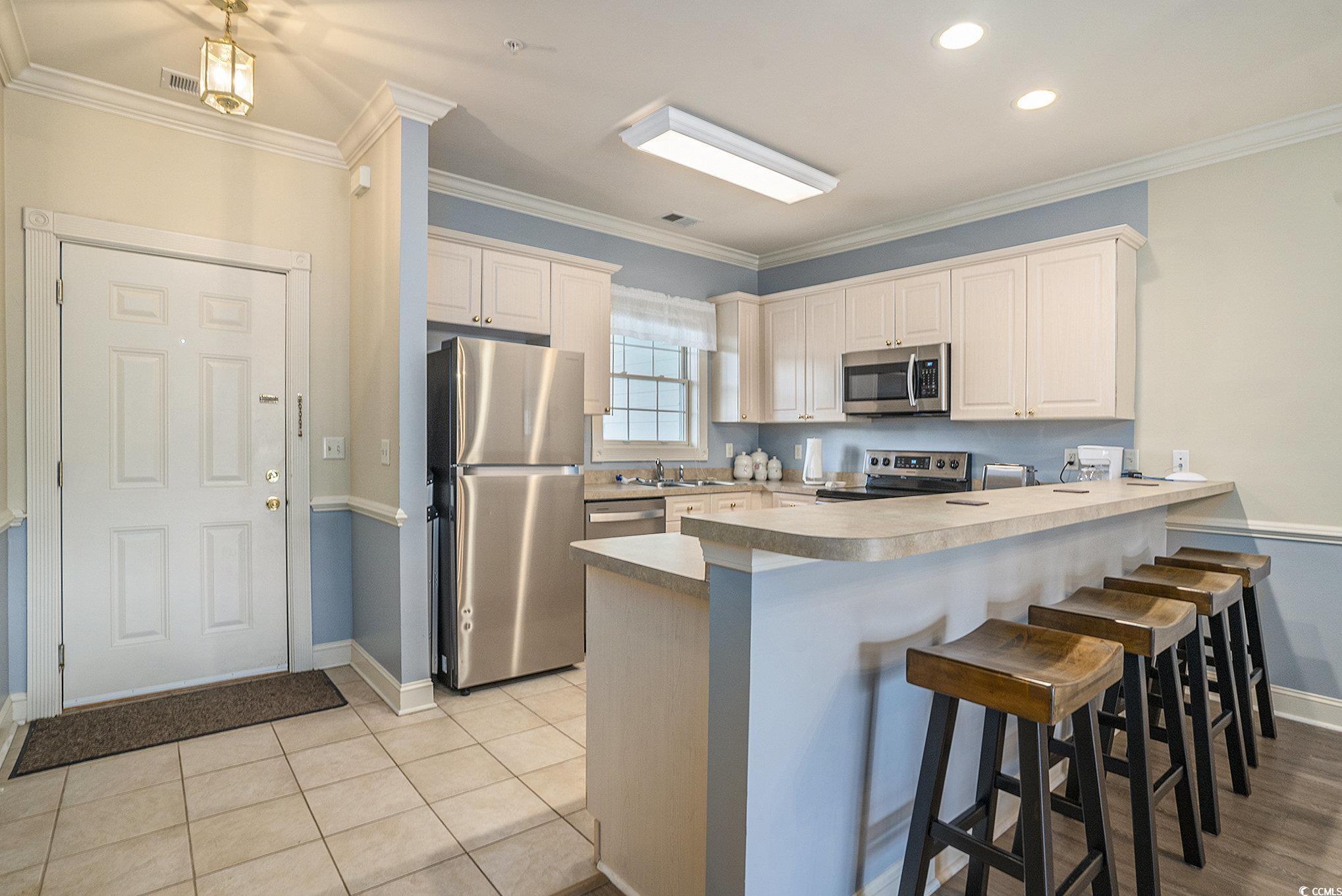 4895 Luster Leaf Circle, Unit 302 Myrtle Beach, SC 29577 - Photo 6 of 20 Kitchen featuring stainless steel appliances, a pe