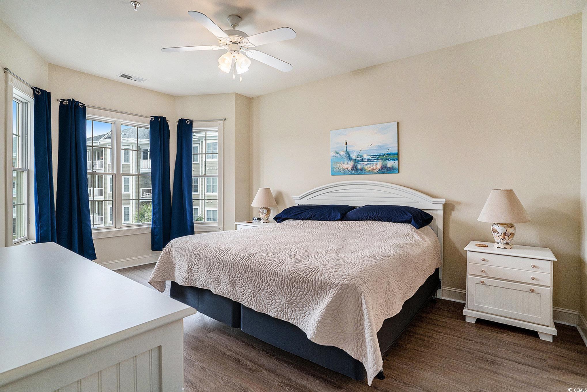4895 Luster Leaf Circle, Unit 302 Myrtle Beach, SC 29577 - Photo 8 of 20 Bedroom featuring dark wood-style floors, baseboar
