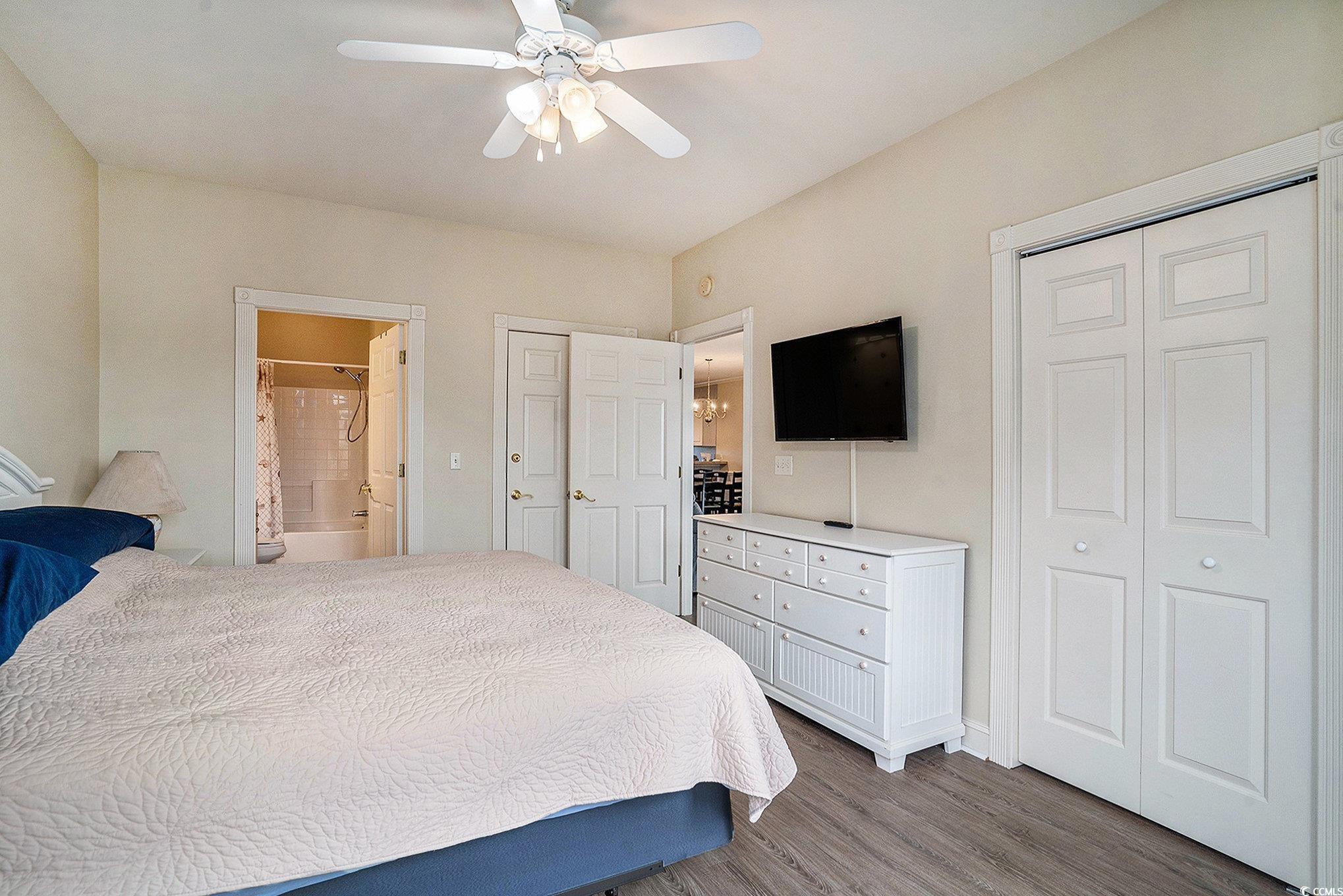 4895 Luster Leaf Circle, Unit 302 Myrtle Beach, SC 29577 - Photo 9 of 20 Bedroom with wood finished floors, ensuite bath, a