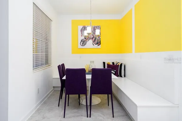 a view of a dining room with furniture and a window