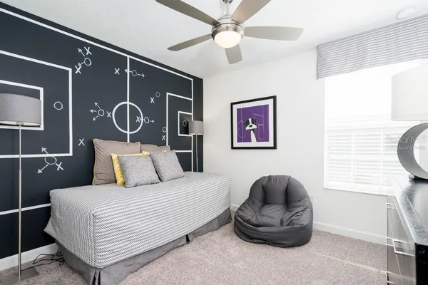 a bedroom with a bed and painting on the wall