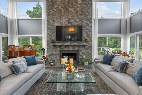 a living room with furniture a fireplace and a flat screen tv