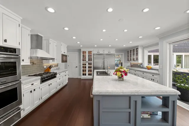 a kitchen with cabinets appliances and a window