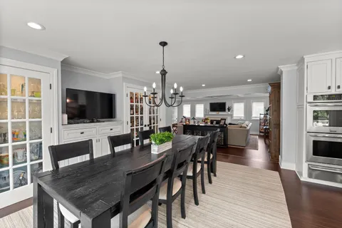 a bedroom with a bed a couch and a flat screen tv