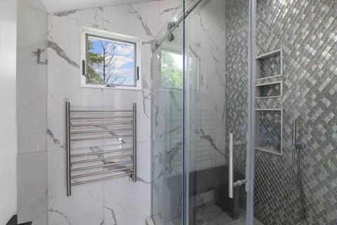 a bathroom with a sink toilet double vanity and shower