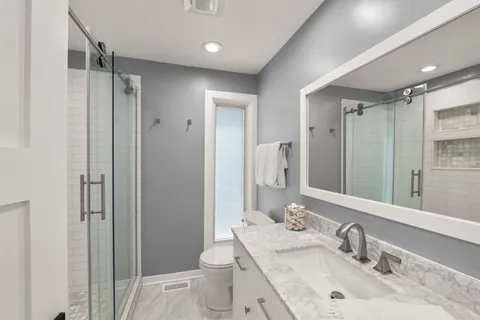 a view of a deck with table and chairs with wooden floor and fence