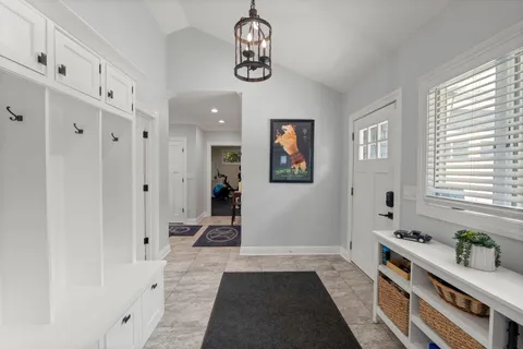 a view of a house with swimming pool and chairs