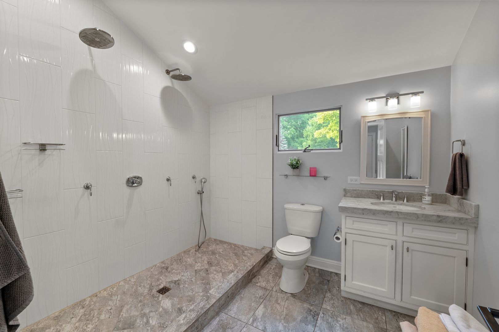 620 West Old Elm Road Lake Forest, IL 60045 - Photo 45 of 77 a spacious bathroom with a granite countertop sink a toilet and a mirror