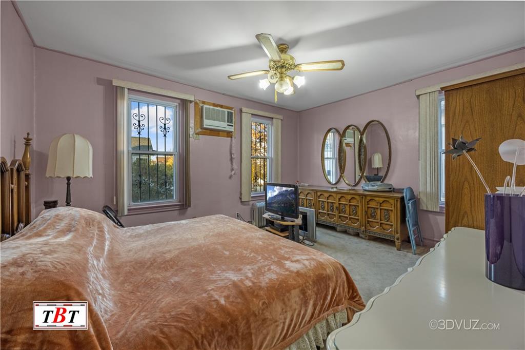 907 Ave. M Brooklyn, NY 11230 - Photo 18 of 22 a bedroom with a bed a chandelier and dresser