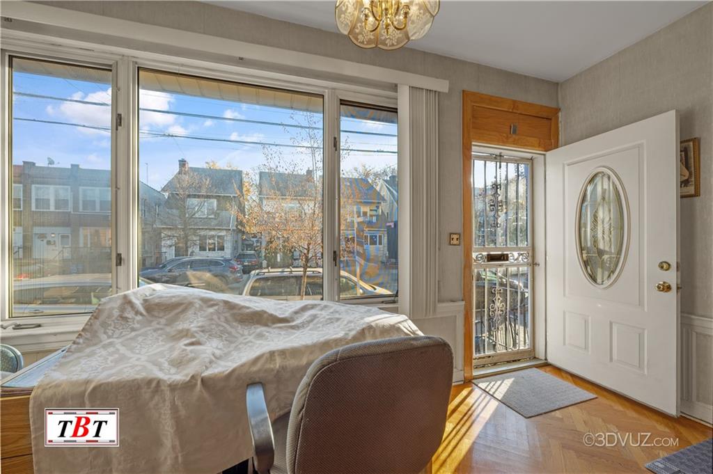 907 Ave. M Brooklyn, NY 11230 - Photo 2 of 22 a spacious bedroom with a large bed and a chandelier
