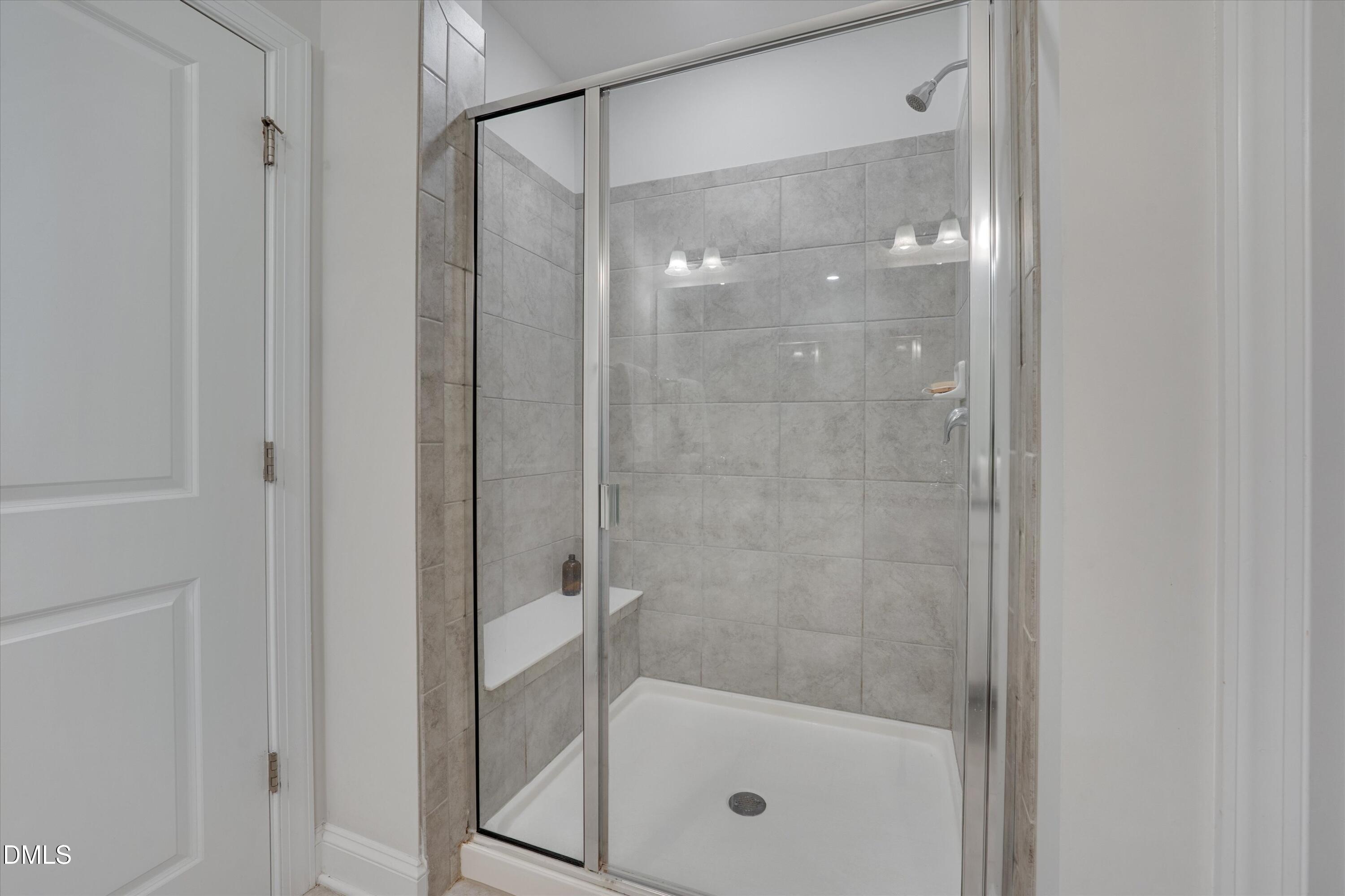 2819 Dallas Valley Lane Apex, NC 27502 - Photo 25 of 38 a bathroom with a glass shower door
