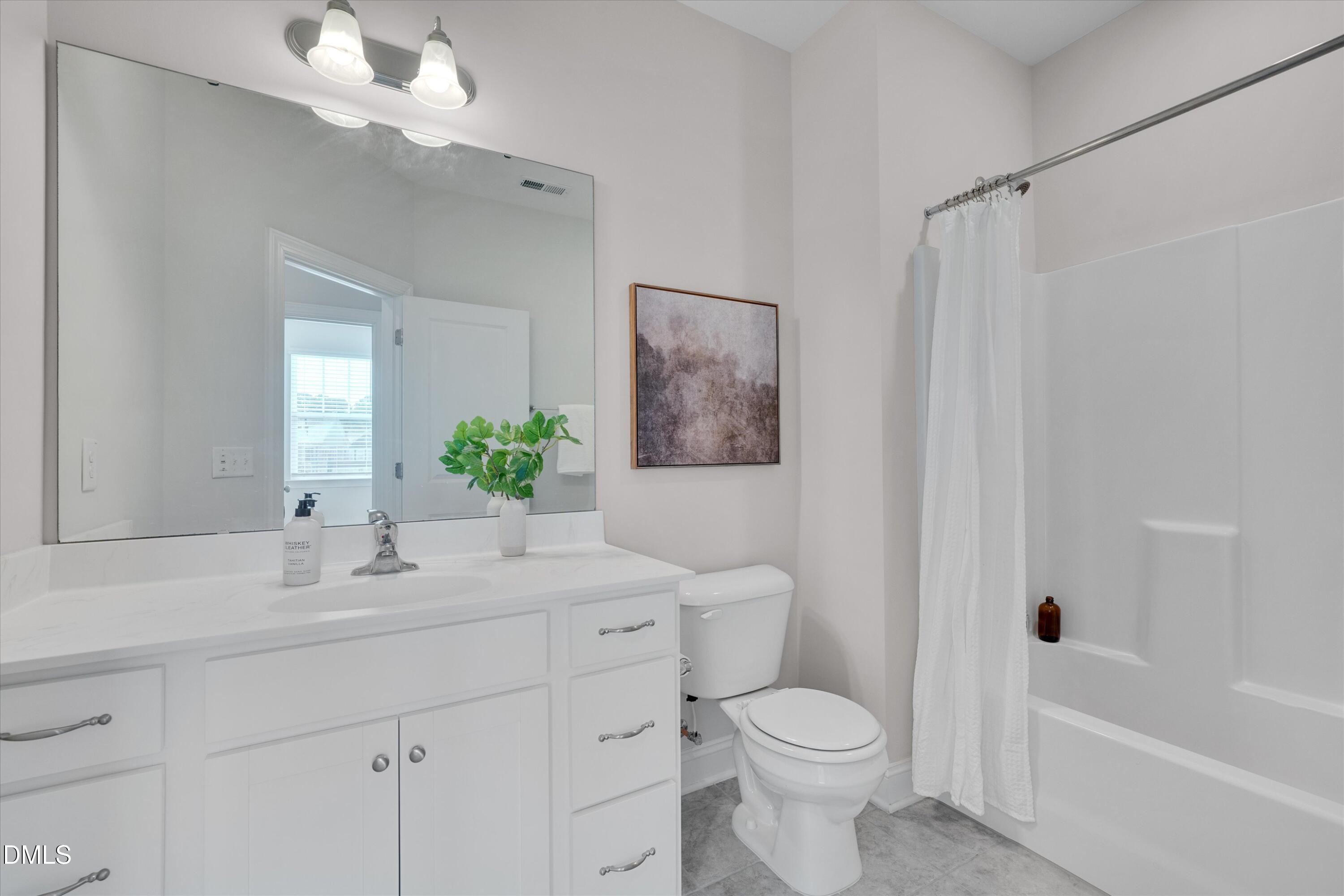 2819 Dallas Valley Lane Apex, NC 27502 - Photo 28 of 38 a bathroom with a toilet a sink and a bathtub