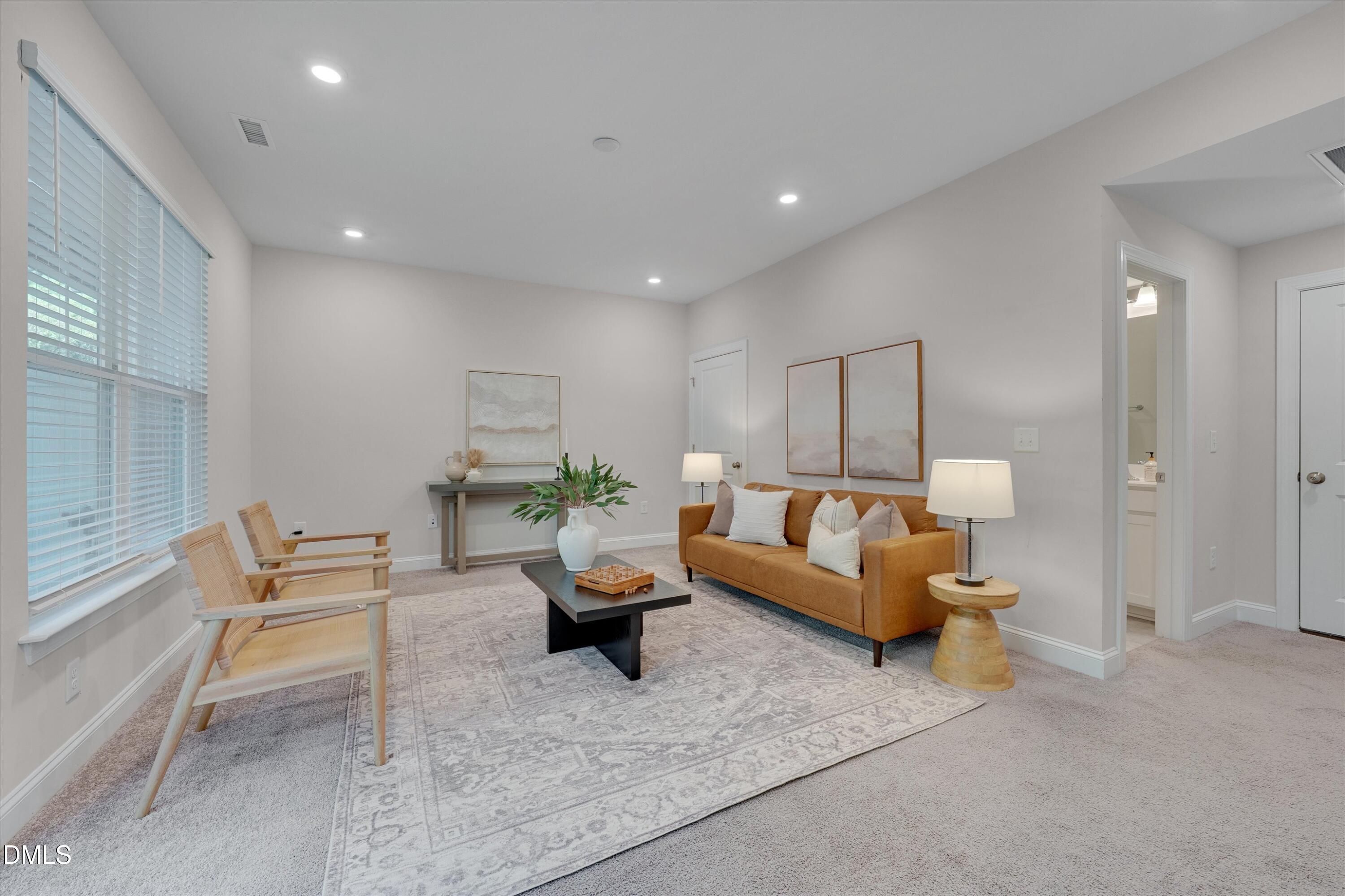 2819 Dallas Valley Lane Apex, NC 27502 - Photo 34 of 38 a living room with furniture and a table
