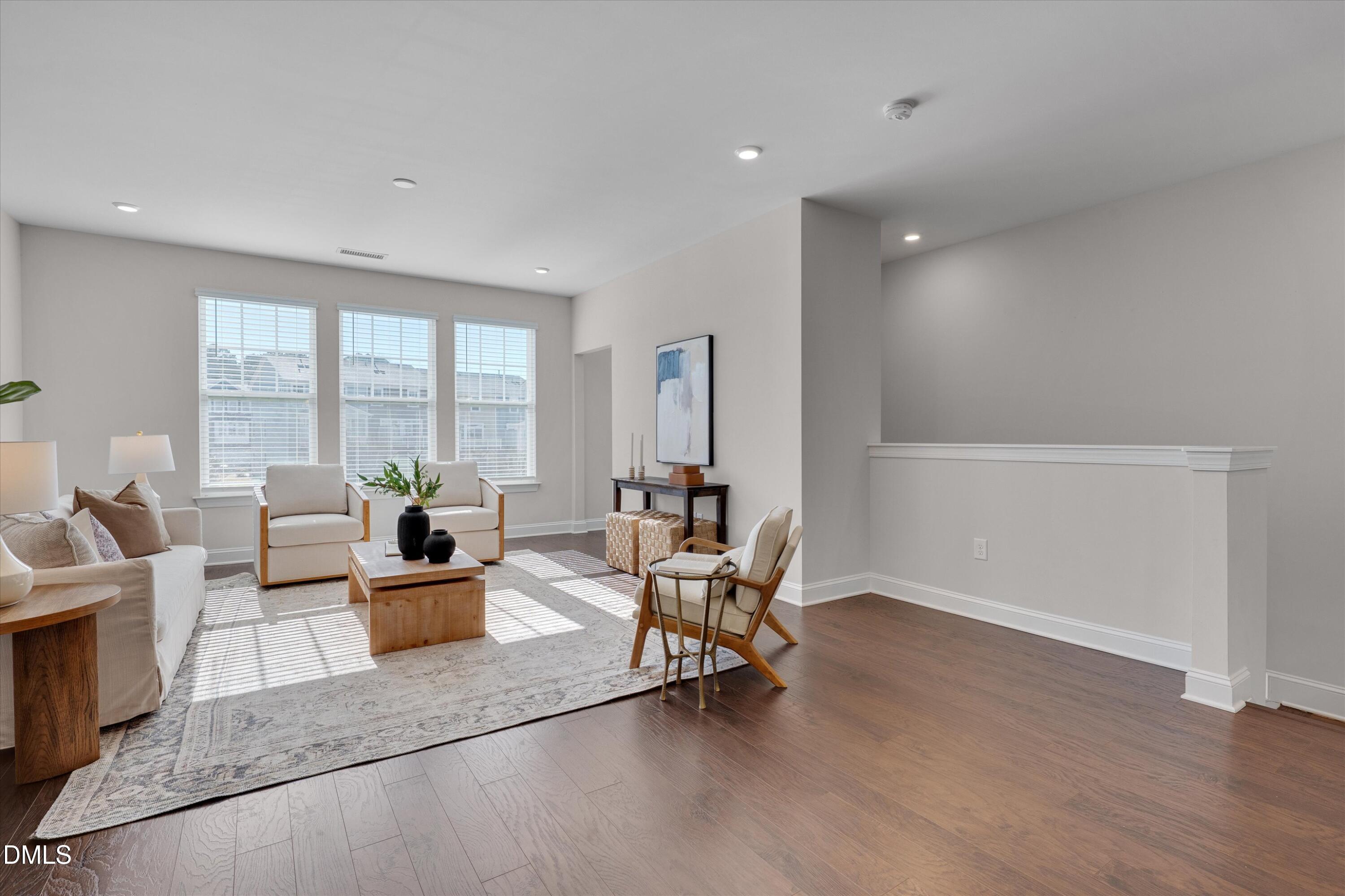 2819 Dallas Valley Lane Apex, NC 27502 - Photo 4 of 38 a living room with furniture and large windows