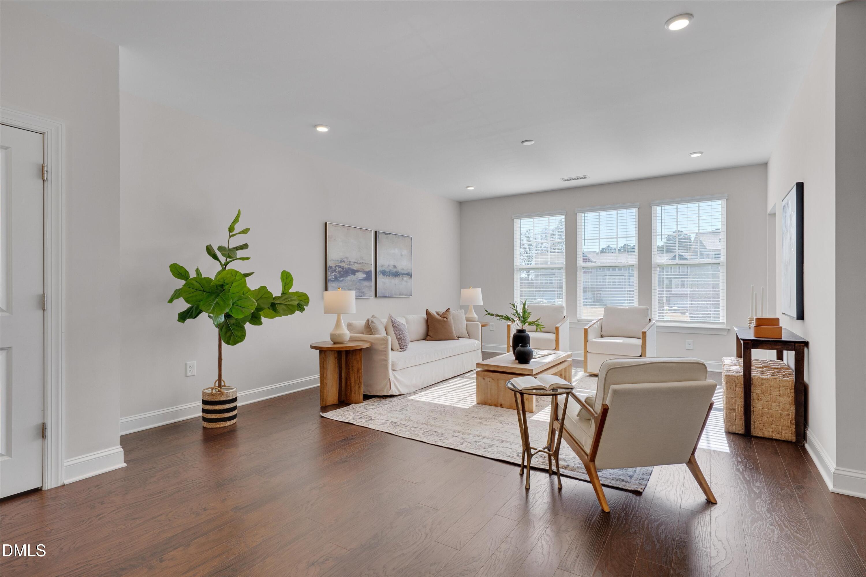 2819 Dallas Valley Lane Apex, NC 27502 - Photo 5 of 38 a living room with furniture potted plant and a large window