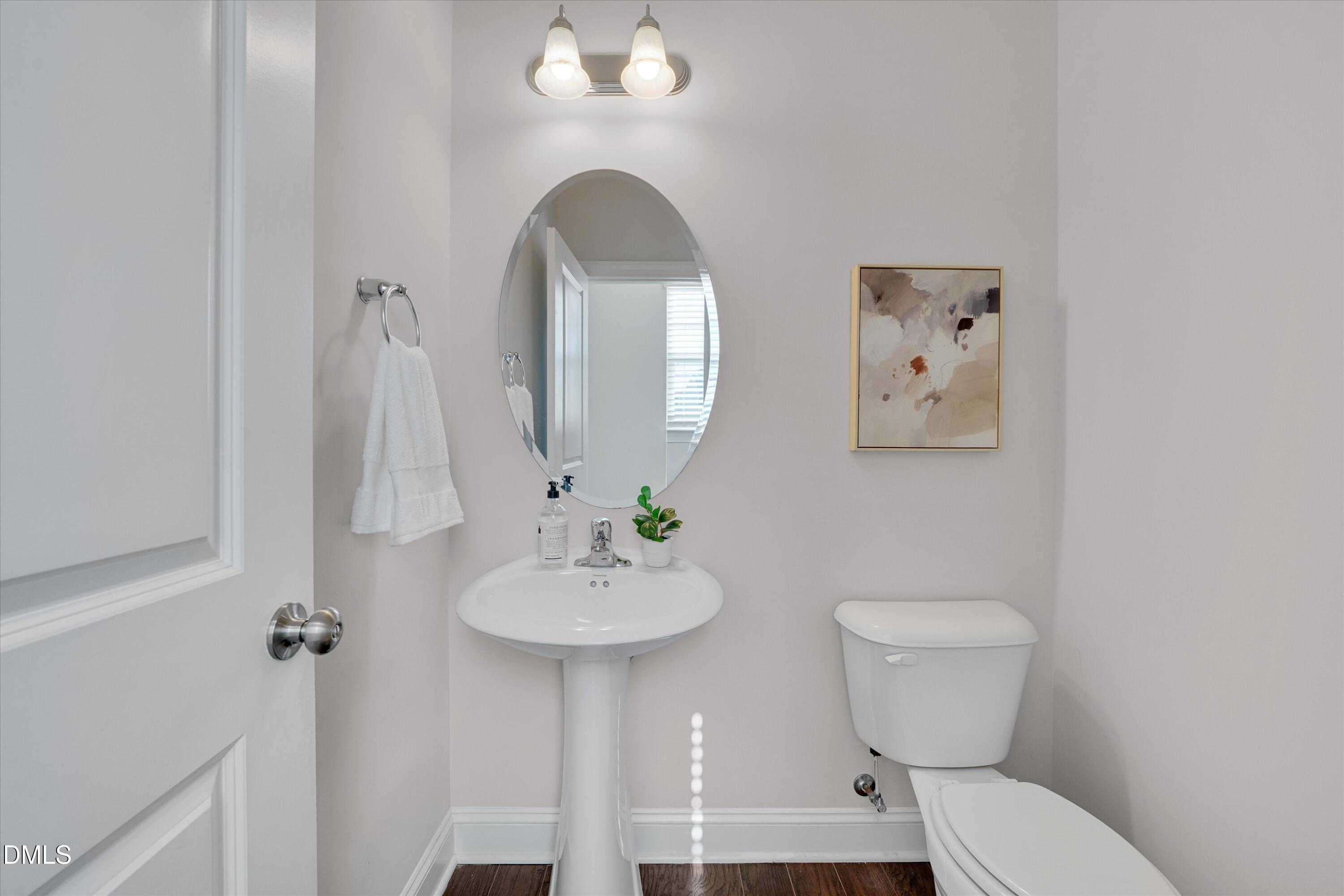 2819 Dallas Valley Lane Apex, NC 27502 - Photo 9 of 38 a bathroom with a toilet sink and mirror