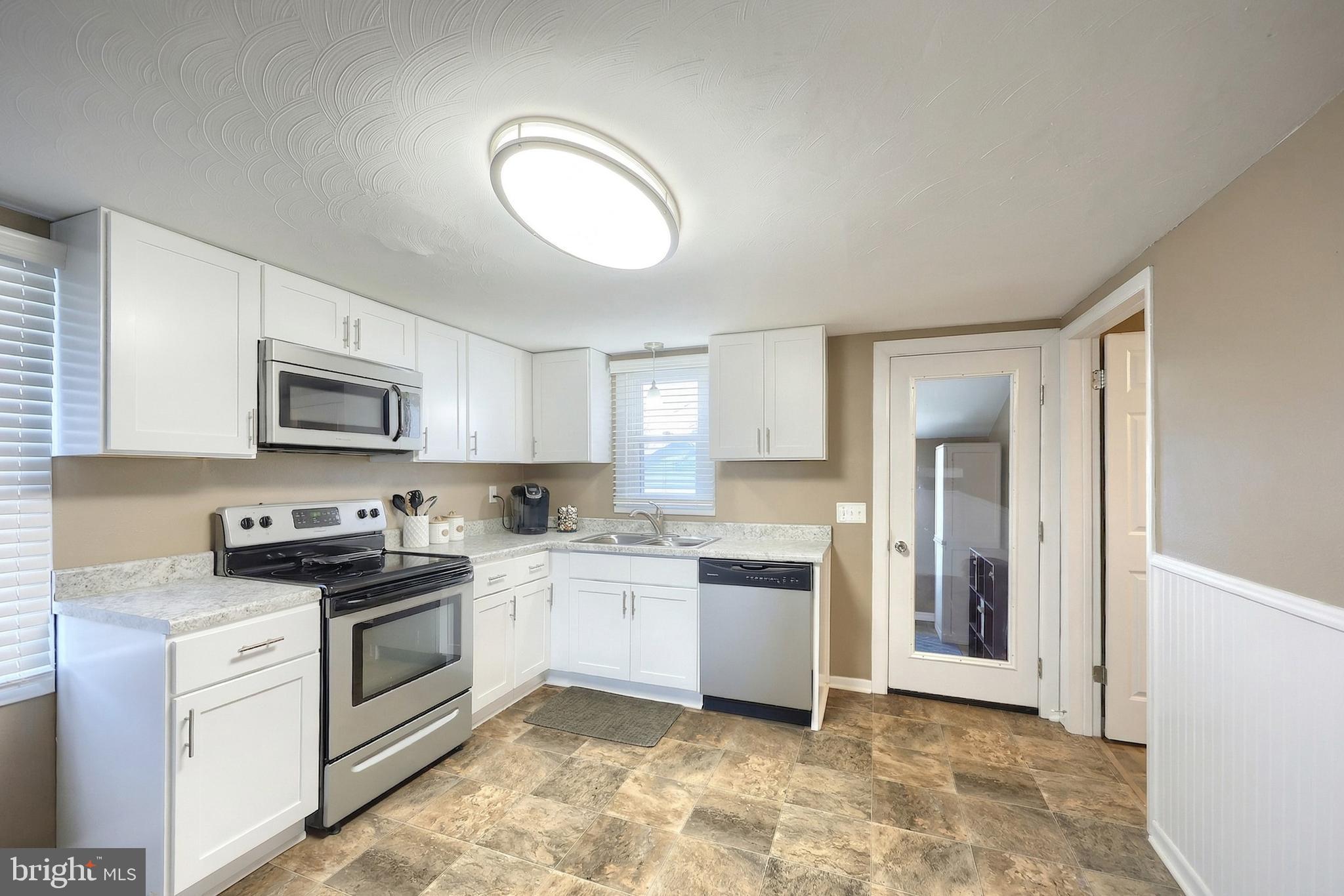 1455 Felton Road Felton, PA 17322 - Photo 13 of 35 a kitchen with a sink stove top oven and cabinets