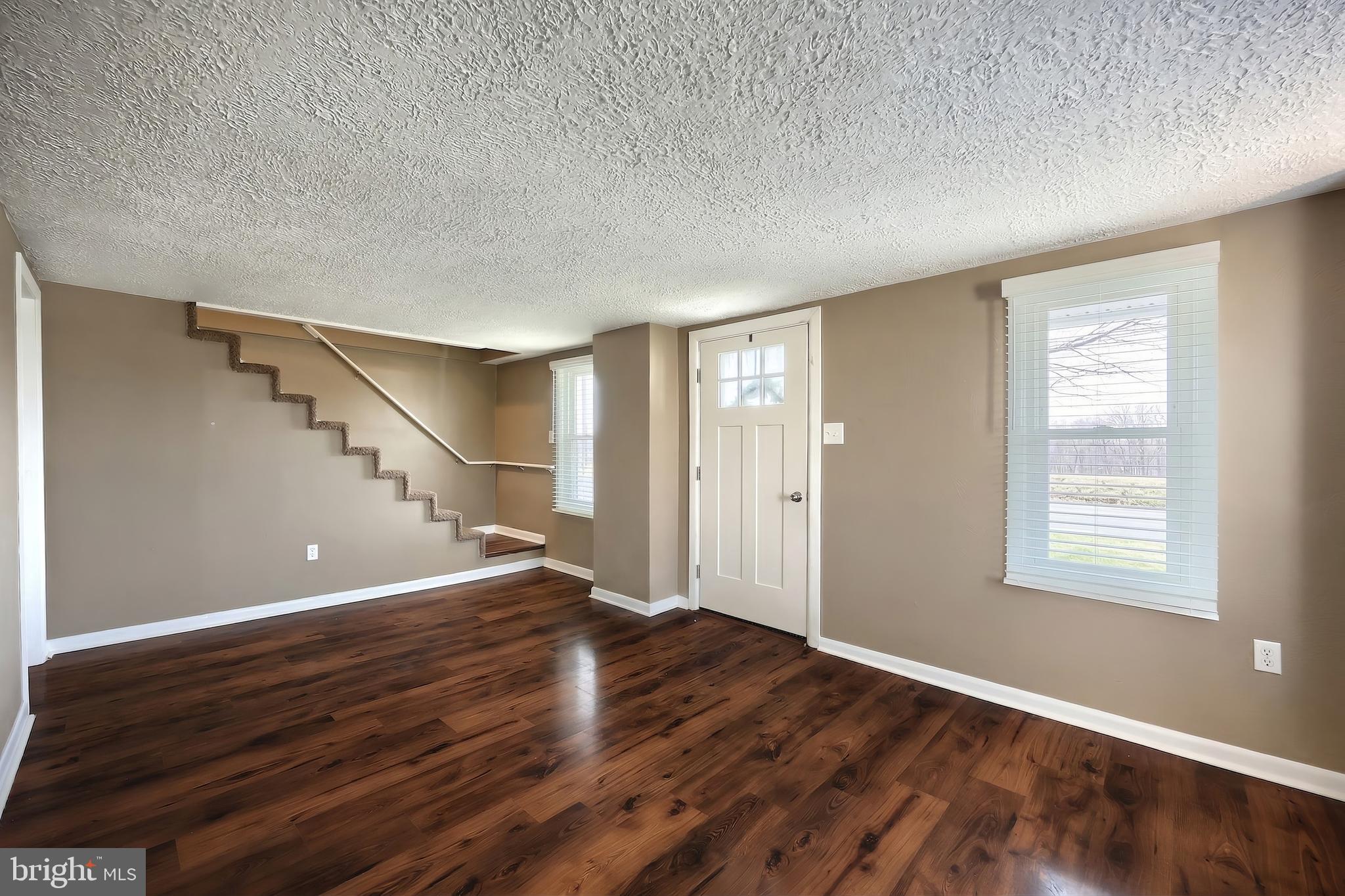 1455 Felton Road Felton, PA 17322 - Photo 9 of 35 a view of an empty room with wooden floor and a window