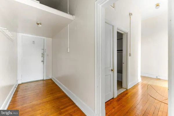 a view of a room with wooden floor