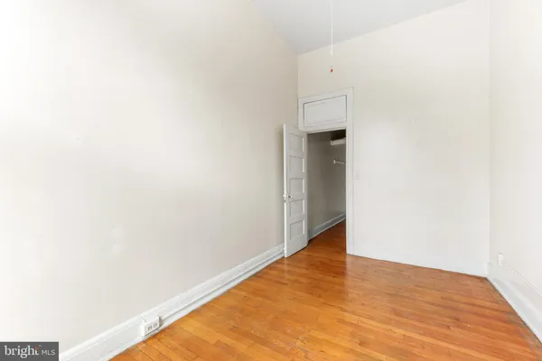 a view of a room with wooden floor and white wall