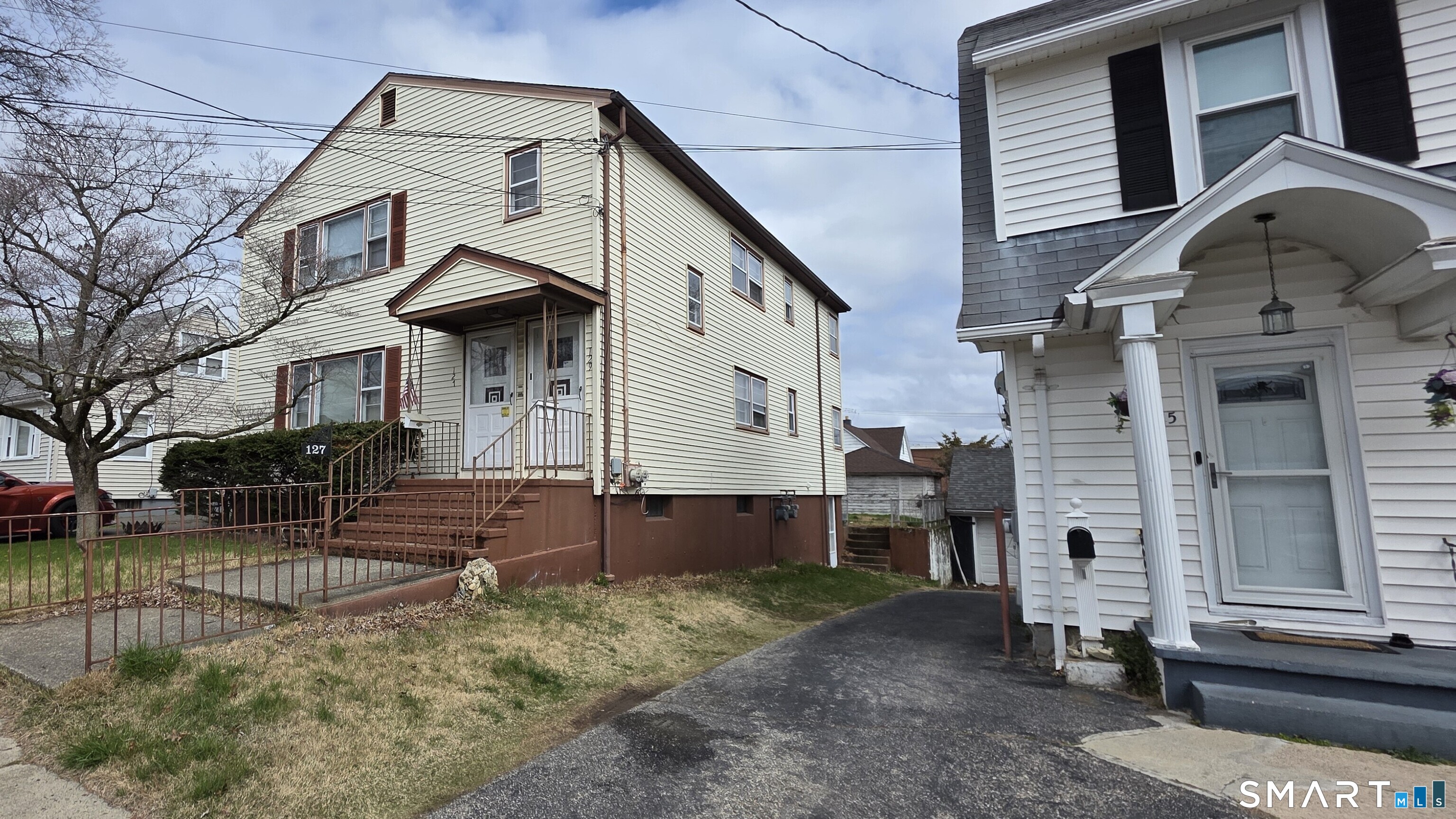 129 Price Street Bridgeport, CT 06610 - Photo 1 of 1 a front view of a house with a yard