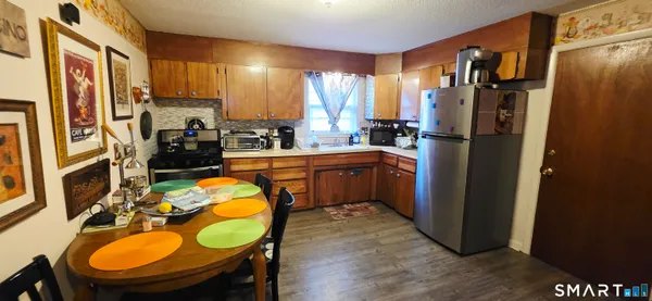 a view of a workspace with furniture and wooden floor