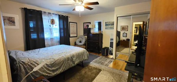 a bed room with furniture and a flat screen tv
