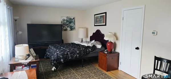 a bedroom with furniture and a window