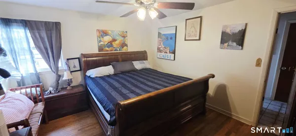 a bedroom with furniture and wooden floor